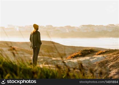 Woman with a yellow cap enjoying the view