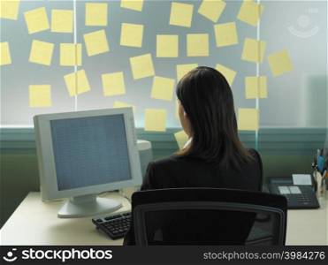 Woman with adhesive notes in her office