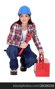 Woman with an adjustable wrench