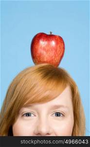 Woman with an apple on top of her head