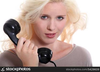 Woman with an old-fashioned telephone handset