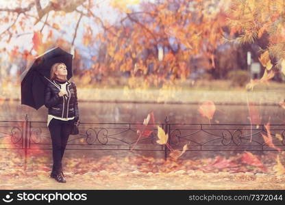 woman with an umbrella in the autumn park