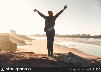 Woman with arms raised enjoying the view