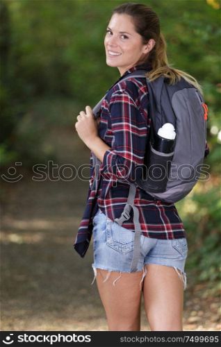 woman with backpack in the nature trail