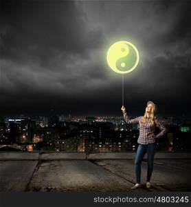 Woman with balloon. Young girl in casual and yin yang sign