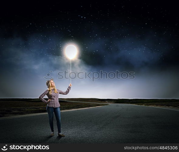 Woman with balloon. Young girl in casual holding balloon on rope