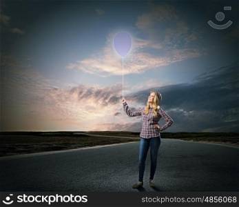 Woman with balloon. Young girl in casual holding balloon on rope