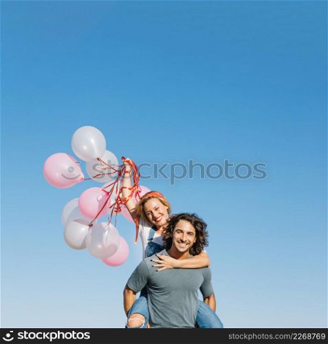woman with balloons back man