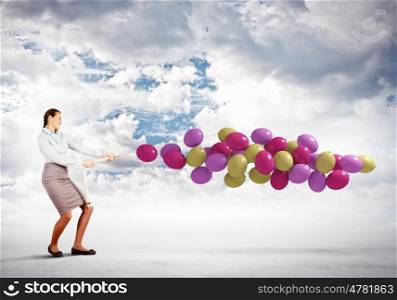 Woman with balloons. Image of young woman holding bunch of colorful balloons