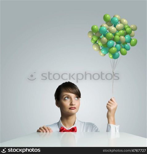 Woman with balloons. Young woman holding bunch of colorful balloons