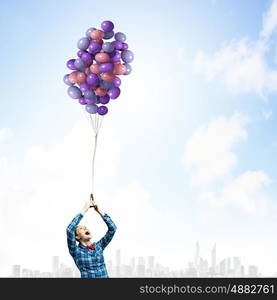 Woman with balloons. Young woman in casual holding bunch of colorful balloons