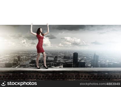 Woman with banner. Pretty woman in red dress with white blank banner