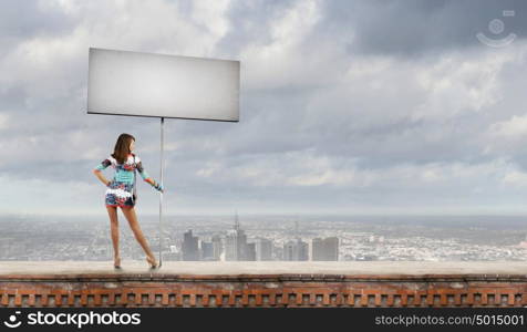 Woman with banner. Rear view of young attractive woman with blank white banner