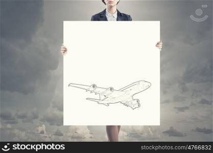 Woman with banner. Unrecognizable woman showing white banner with airplane design