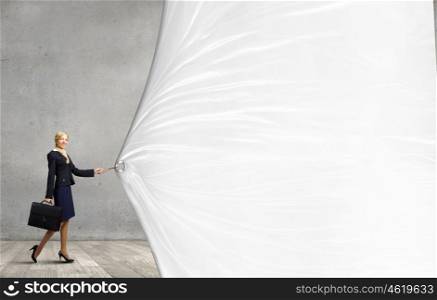Woman with banner. Young businesswoman pulling white banner with lead