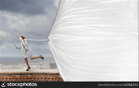 Woman with banner. Young businesswoman running and pulling white blank banner