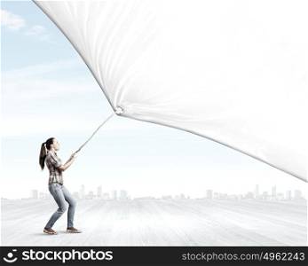 Woman with banner. Young woman in casual pulling white blank banner