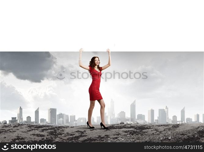 Woman with banner. Young woman in red dress holding white blank banner