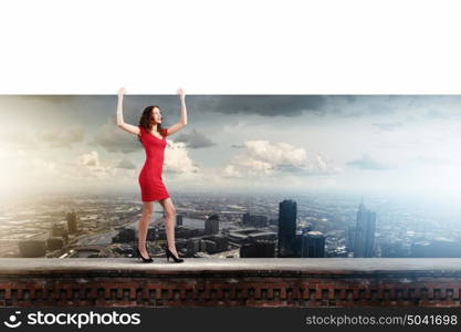 Woman with banner. Young woman in red dress holding white blank banner