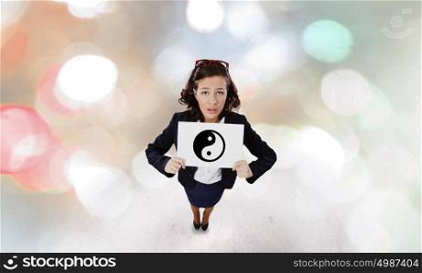 Woman with banner. Young woman in suit holding banner with yin yang sign