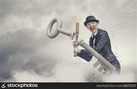 Woman with baseball bat. Young emotional woman in suit and hat with baseball bat