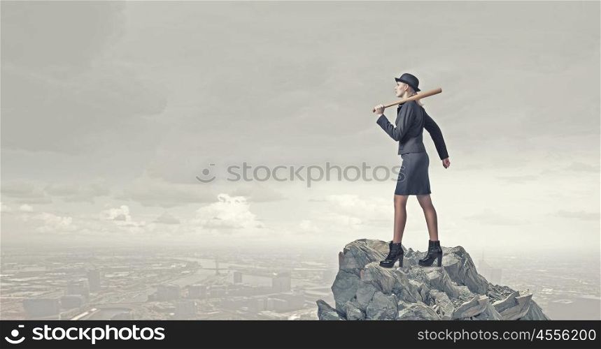 Woman with baseball bat. Young pretty woman in suit and hat with baseball bat