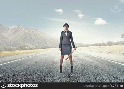 Woman with baseball bat. Young pretty woman in suit and hat with baseball bat