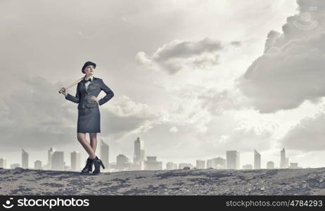 Woman with baseball bat. Young pretty woman in suit and hat with baseball bat