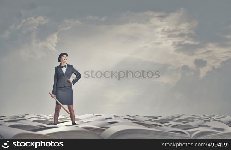 Woman with baseball bat. Young pretty woman in suit and hat with baseball bat