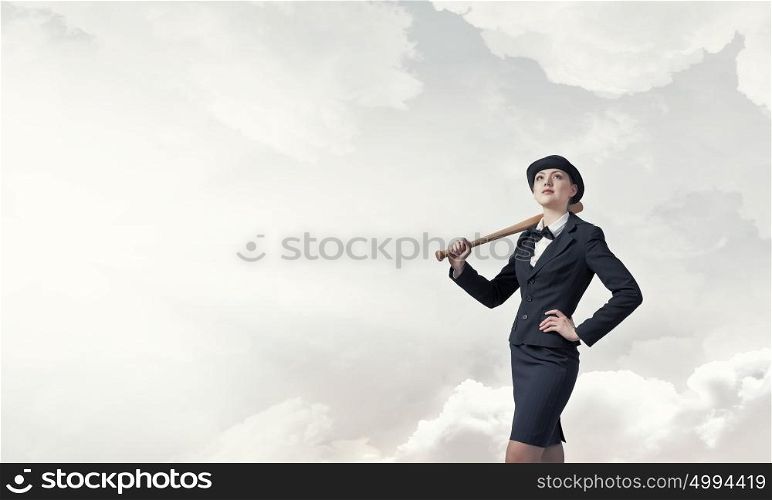 Woman with baseball bat. Young pretty woman in suit and hat with baseball bat