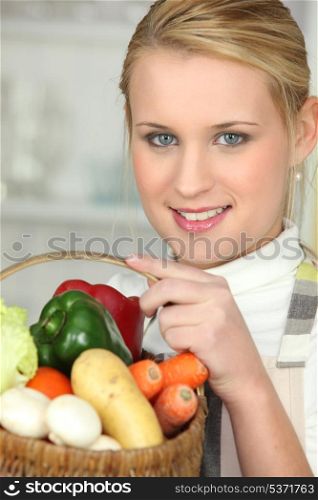 Woman with basket full of vegetables