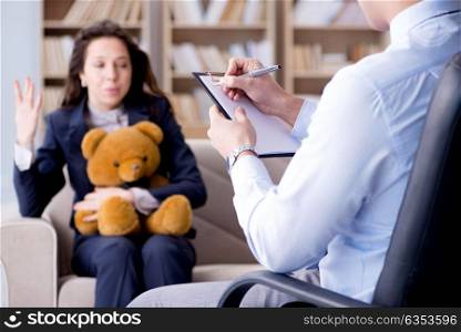 Woman with bear toy during psychologist visit