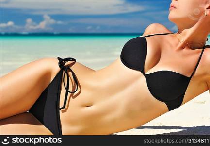Woman with beautiful body on a tropical beach
