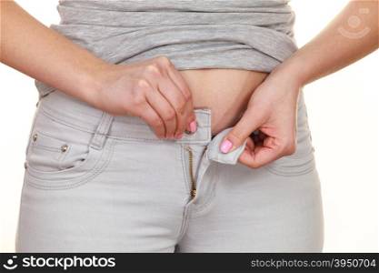 Woman with belly fat unable to close the pants . Woman with belly fat getting dressed putting pants on. Overweight female trying to fasten too small trousers isolated. Weight gain diet concept