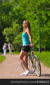 woman with bicycle in park