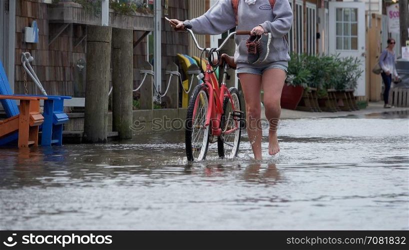 Woman with bike in a flood