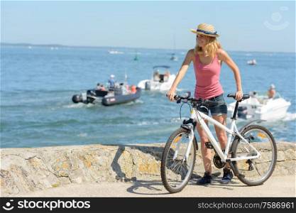 woman with bike on beach