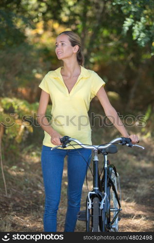 woman with bike outdoors in the nature