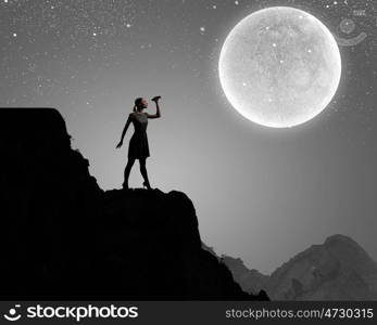 Woman with binoculars. Silhouette of woman at night looking in binoculars