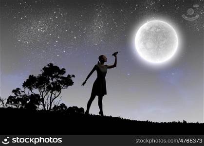 Woman with binoculars. Silhouette of woman at night looking in binoculars