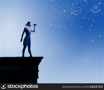 Woman with binoculars. Silhouette of woman at night looking in binoculars