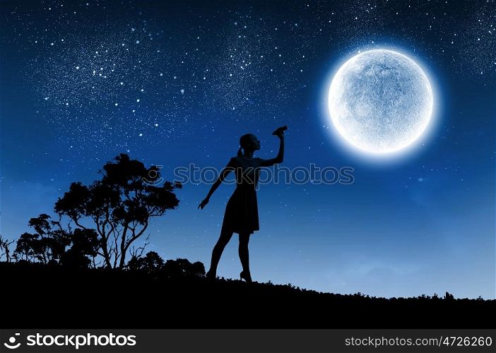 Woman with binoculars. Silhouette of woman looking in binoculars with big full moon at background