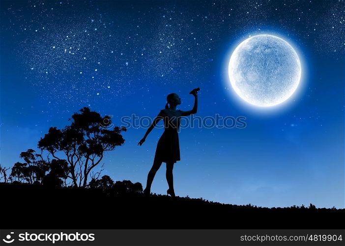 Woman with binoculars. Silhouette of woman looking in binoculars with big full moon at background