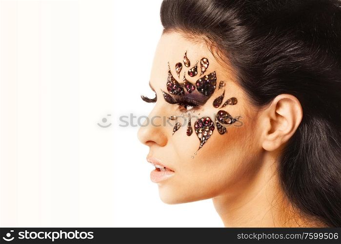 Woman with black hair and art make up on white background