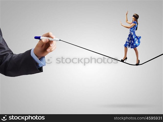 Woman with blindfold. Young woman in blue dress walking on line