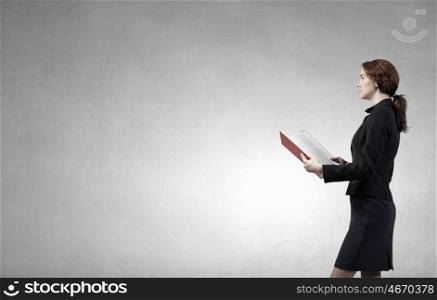 Woman with book. Young businesswoman with red book in hands