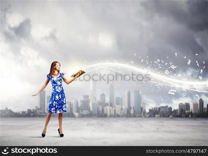 Woman with book. Young woman in blue dress reading book