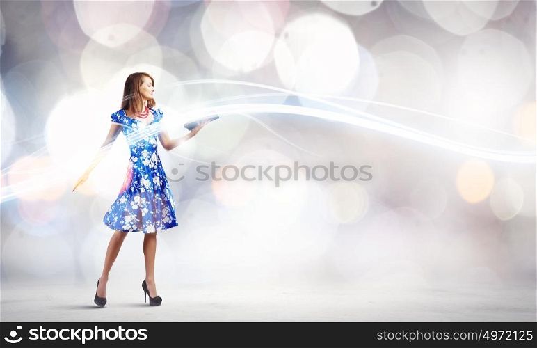 Woman with book. Young woman in blue dress reading book
