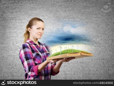 Woman with book. Young woman in casual holding opened book with windmills