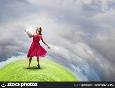 Woman with book. Young woman in red dress with book in hand